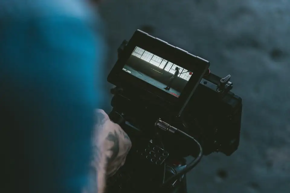Camera operator holding a cinema camera with a monitor