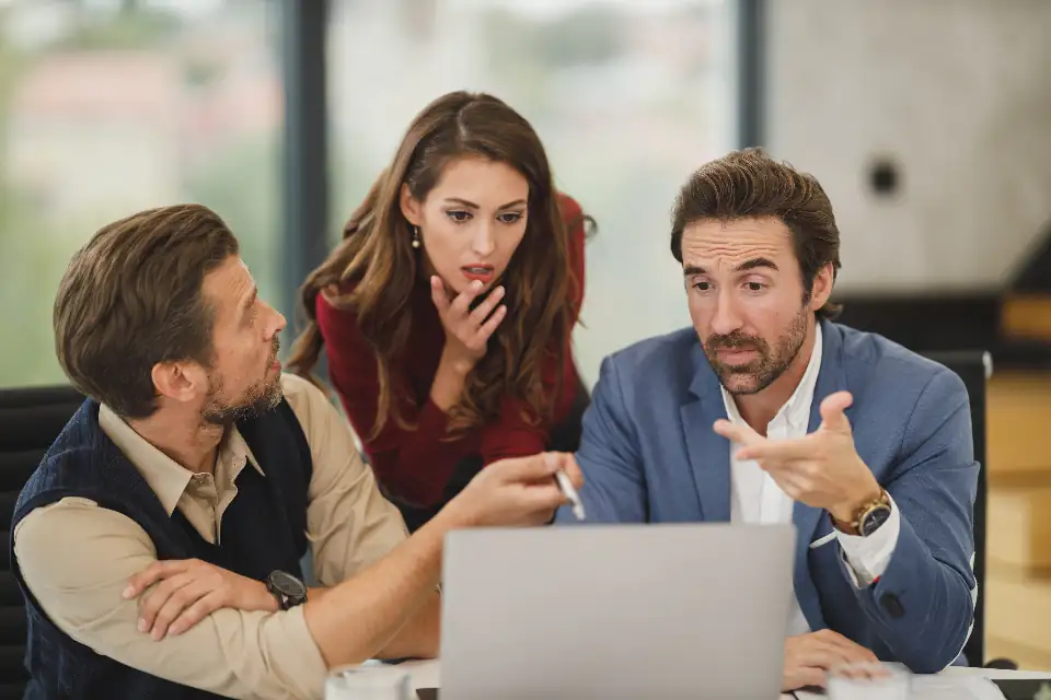 Colleagues reviewing a project on a laptop