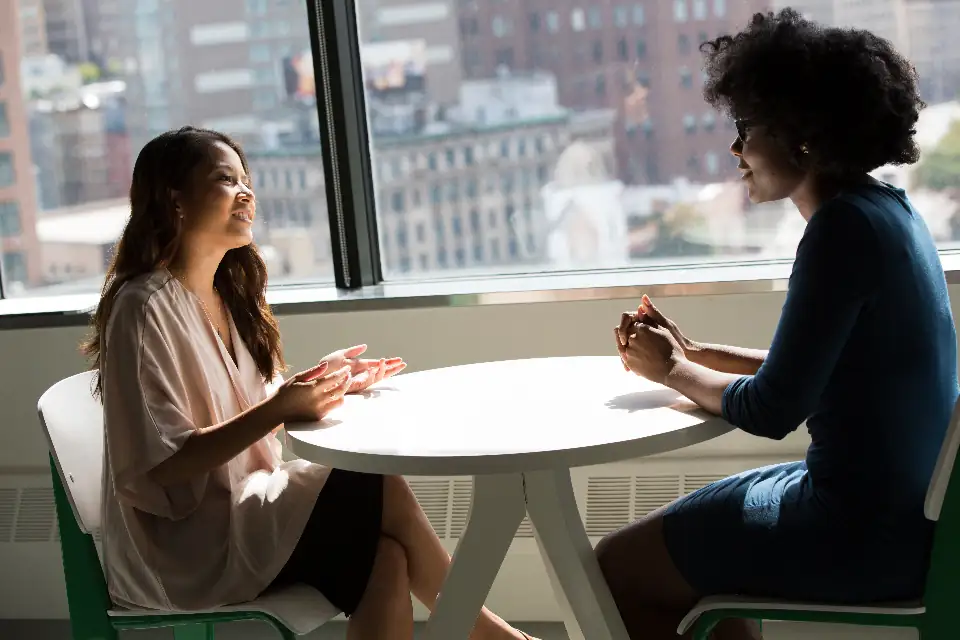 Two people talking at a table during an interview