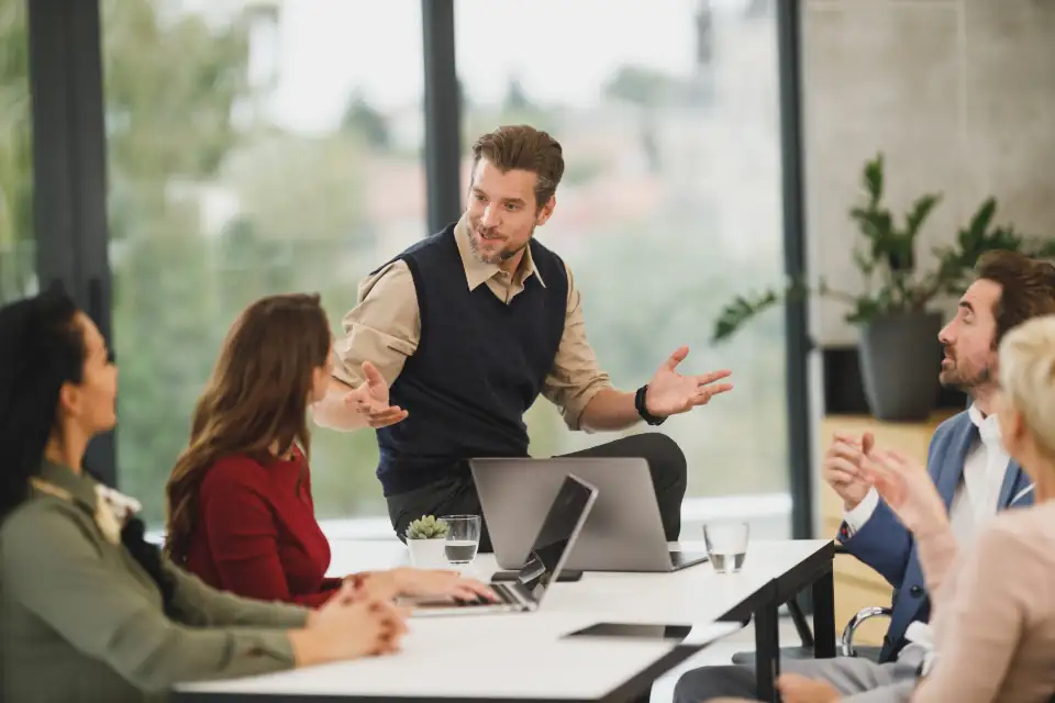 Manager leading a meeting in a bright office