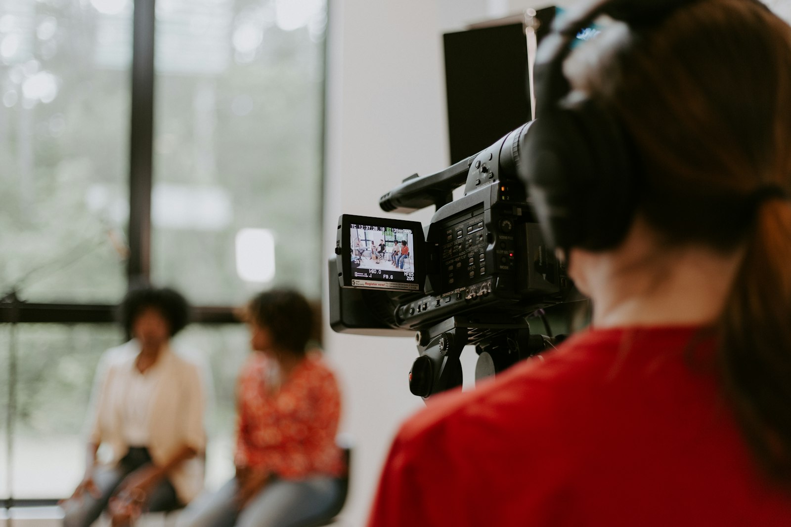Camera operator filming a two-person interview for a corporate video
