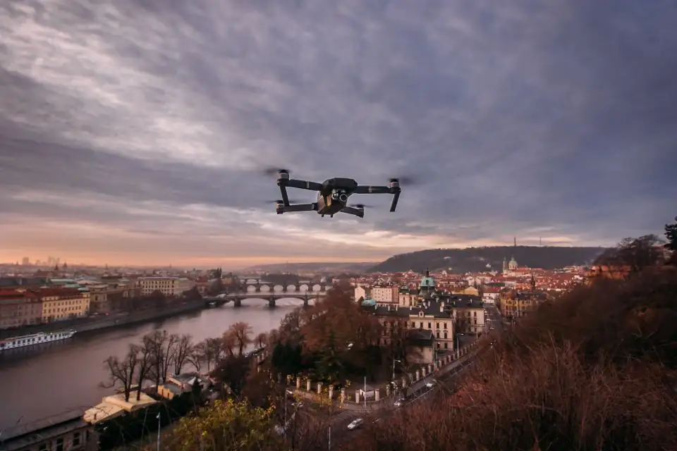 Drone flying over a city skyline at dusk