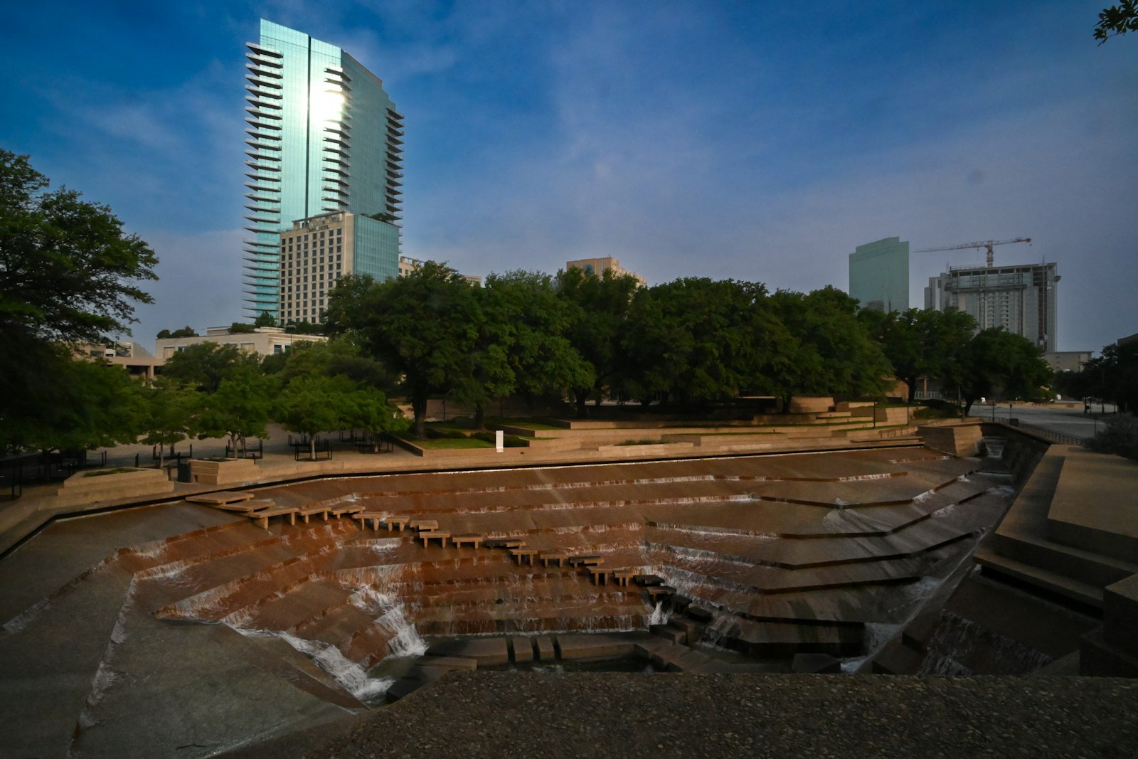 Terraced concrete pools at the Fort Worth Water Gardens with downtown towers behind
