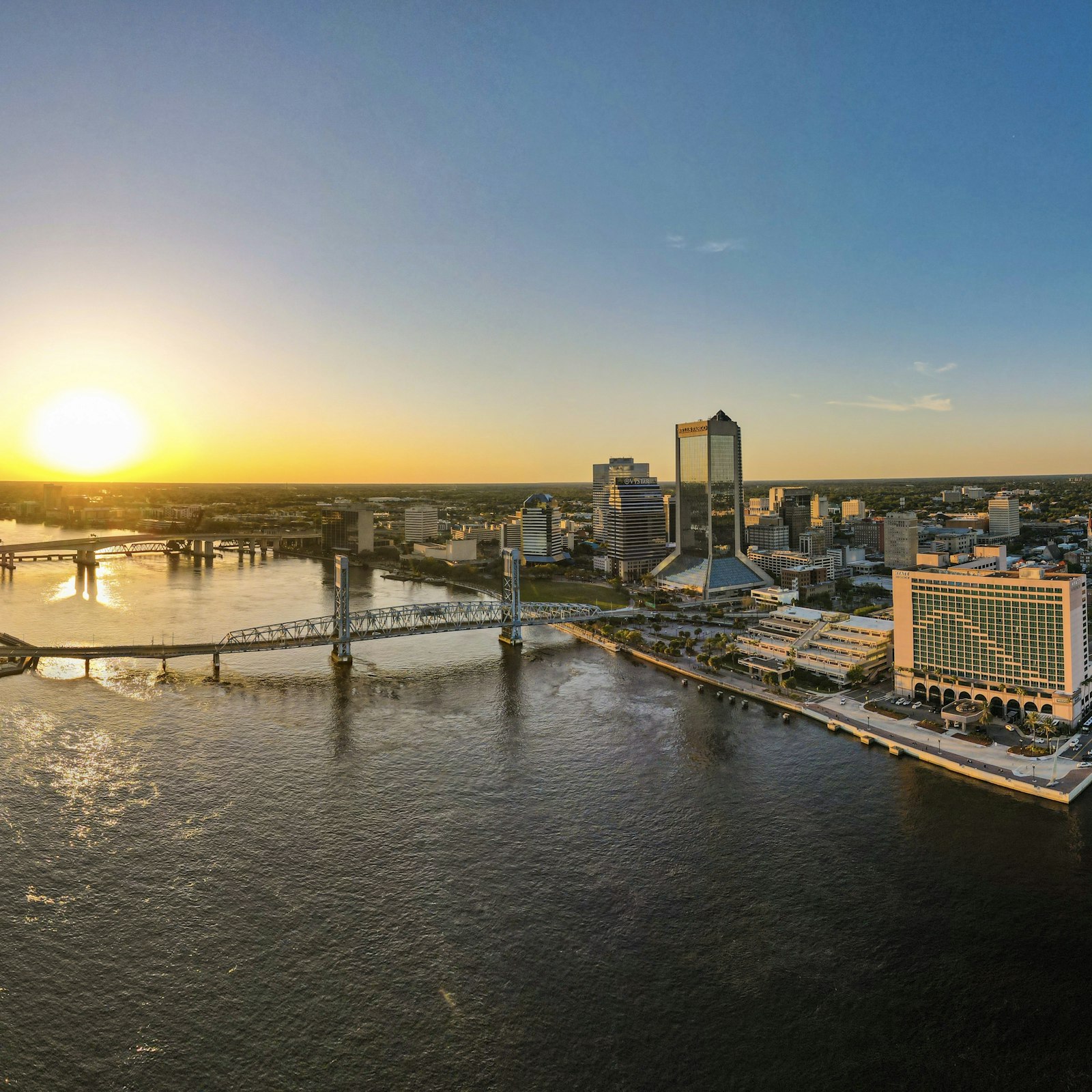 Downtown Jacksonville and a river bridge at sunset